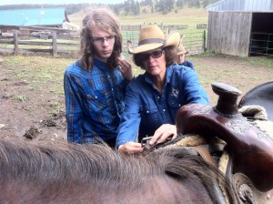 Maggie working with Sam to Saddle a horse.