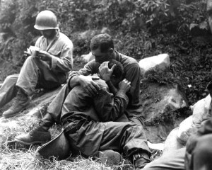One soldier comforts another who is grief stricken over the death of a buddy killed in action during the Korean War.