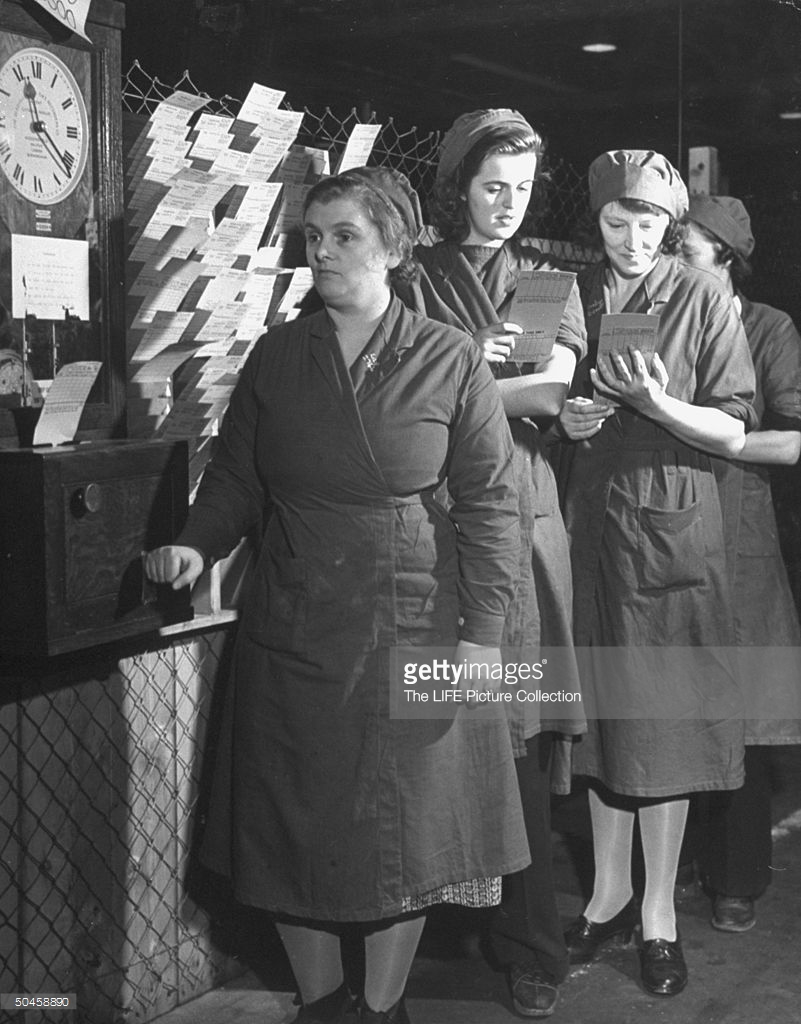 Women waiting in line to have their time cards punched 1942